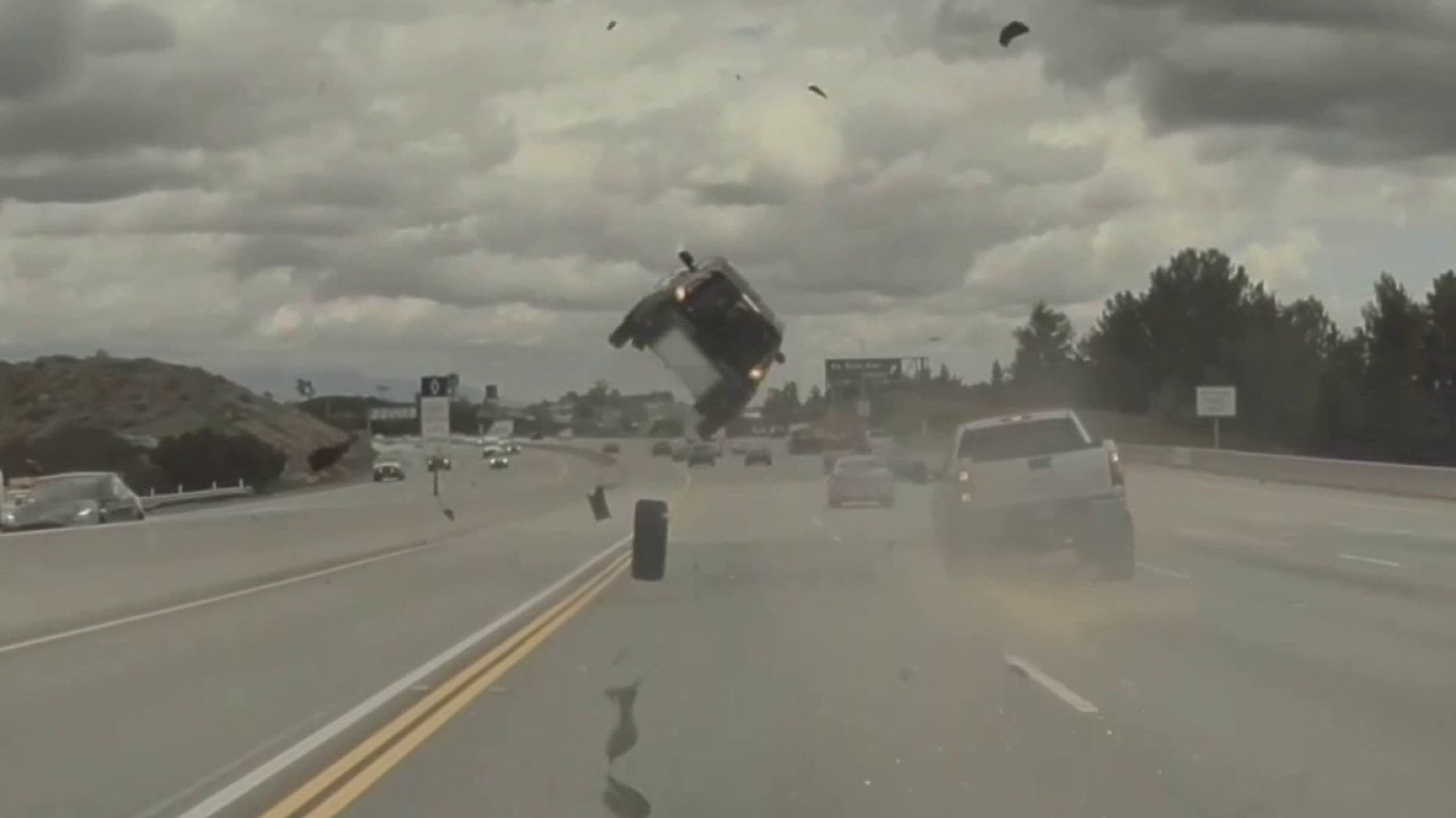 Car-flips-on-Los-Angeles-freeway-after-tire-pops-off-pickup-truck-video-shows.jpg