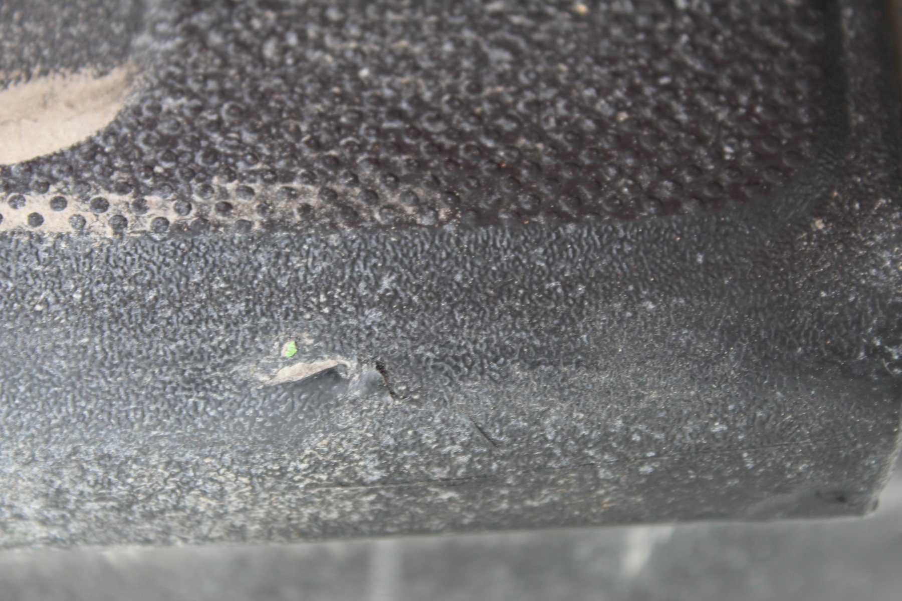 bumper cover damage  with green servPro paint.JPG